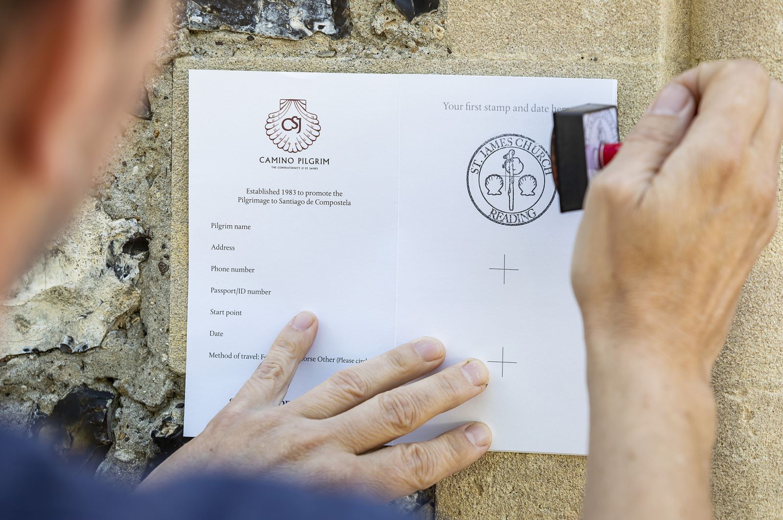 Camino pilgrim passport being stamped